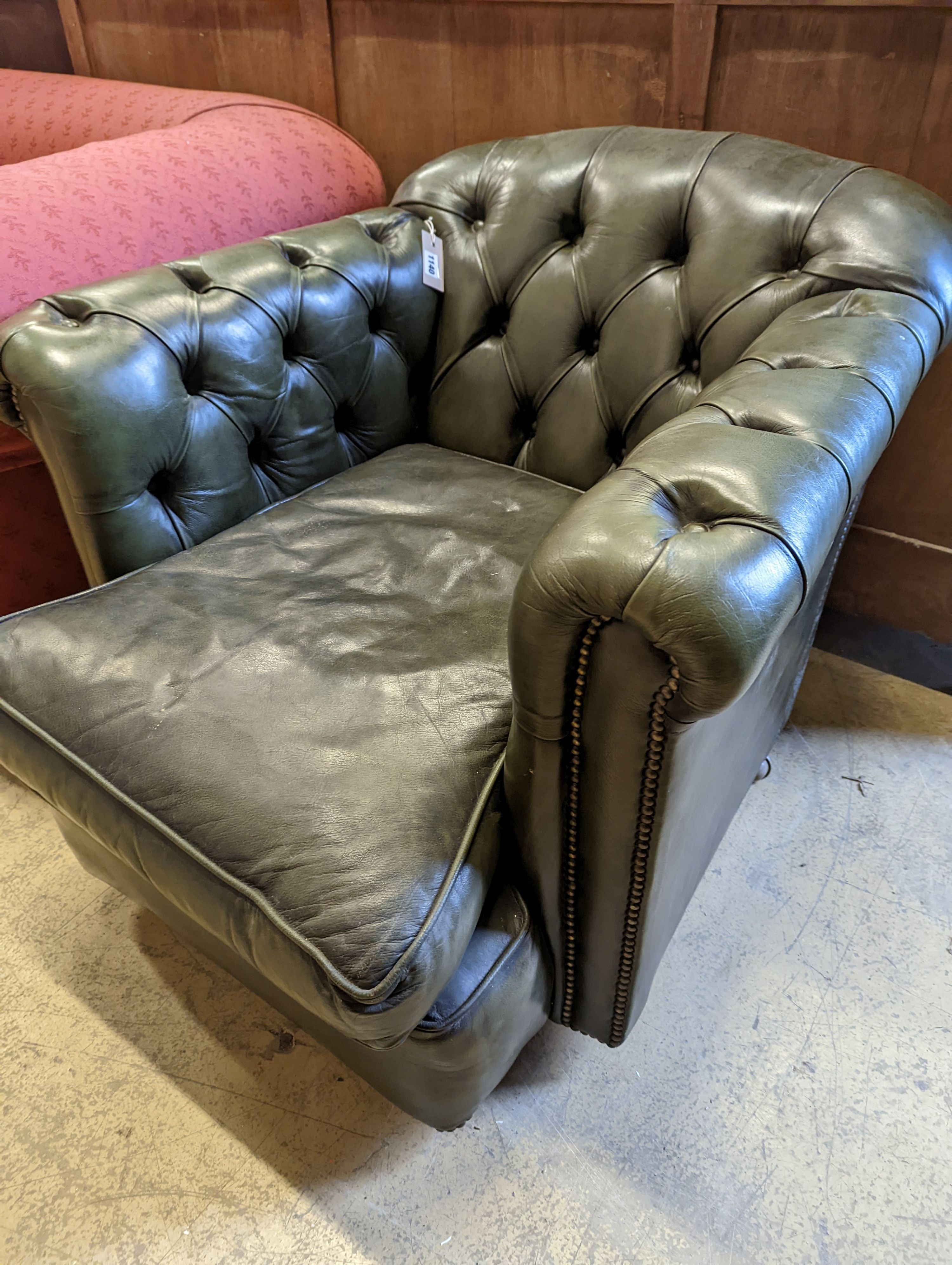 A Victorian style buttoned green leather club armchair, width 85cm, depth 100cm, height 72cm